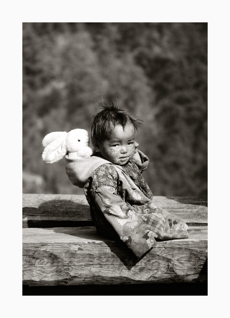 Fine art image of a Langtang valley infant with white toy rabbit from the '90s, Nepal.