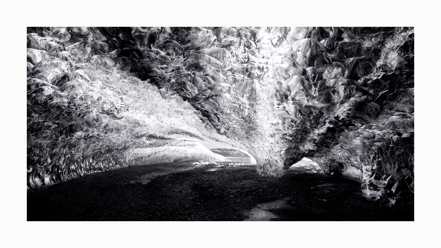 Fine art black and white image of Northern Lights Ice Cave Entrance from the Vatnajökull Glacier, Iceland.